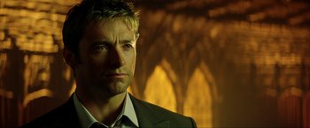 Movie still from “Swordfish” (2001), directed by Dominic Sena – A person wearing a suit and tie; Close Up shot, Over the shoulder angle