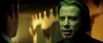 Movie still from “Swordfish” (2001), directed by Dominic Sena – A person wearing a green shirt; Close Up shot, Over the shoulder angle