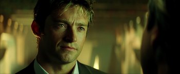 Movie still from “Swordfish” (2001), directed by Dominic Sena – A person wearing a suit and tie; Close Up shot, Low angle