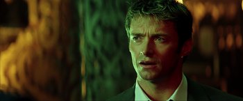 Movie still from “Swordfish” (2001), directed by Dominic Sena – A person wearing a suit and tie; Close Up shot, Low angle