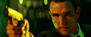 Movie still from “Swordfish” (2001), directed by Dominic Sena – A man's face in a green light; Close Up shot, Low angle