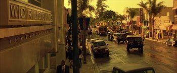 Movie still from “Swordfish” (2001), directed by Dominic Sena – A busy street with cars parked on the side of the road; Extreme Wide shot, High angle