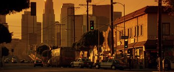 Movie still from “Swordfish” (2001), directed by Dominic Sena – A city street with cars parked on the side of the road; Extreme Wide shot, Low angle
