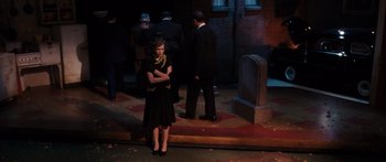 Movie still from “Synecdoche, New York” (2008), directed by Charlie Kaufman – A group of people standing around a building at night; Wide shot, High angle