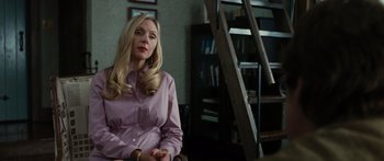 Movie still from “Synecdoche, New York” (2008), directed by Charlie Kaufman – A woman sitting in a chair in front of a bookshelf; Medium shot, Over the shoulder angle