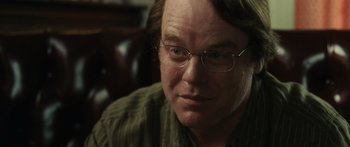 Movie still from “Synecdoche, New York” (2008), directed by Charlie Kaufman – A person wearing glasses; Close Up shot, Over the shoulder angle
