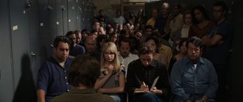 Movie still from “Synecdoche, New York” (2008), directed by Charlie Kaufman – A group of people sitting in front of each other in a room; Medium shot, High angle