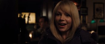 Movie still from “Synecdoche, New York” (2008), directed by Charlie Kaufman – A woman with blonde hair smiles at the camera; Close Up shot, Over the shoulder angle