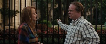 Movie still from “Synecdoche, New York” (2008), directed by Charlie Kaufman – A man and a woman standing next to each other near a fence; Medium shot, Over the shoulder angle