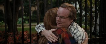 Movie still from “Synecdoche, New York” (2008), directed by Charlie Kaufman – A man and a woman hug in front of an iron fence; Close Up shot, Over the shoulder angle