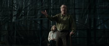 Movie still from “Synecdoche, New York” (2008), directed by Charlie Kaufman – An older man and a young woman in front of an audience; Medium shot, Low angle