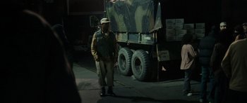 Movie still from “Synecdoche, New York” (2008), directed by Charlie Kaufman – A man standing in front of a truck at night; Wide shot, Low angle