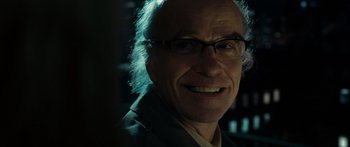 Movie still from “Synecdoche, New York” (2008), directed by Charlie Kaufman – An older man wearing glasses and smiling for the camera; Close Up shot, Over the shoulder angle