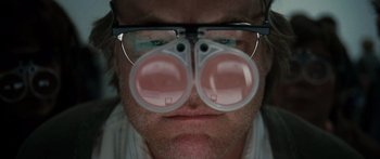 Movie still from “Synecdoche, New York” (2008), directed by Charlie Kaufman – A person's eyes wearing glasses; Extreme Close Up shot, Overhead angle