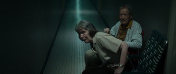 Movie still from “Synecdoche, New York” (2008), directed by Charlie Kaufman – An older man and a younger woman in a hallway; Wide shot, High angle