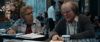 Movie still from “Synecdoche, New York” (2008), directed by Charlie Kaufman – A man and a woman sitting at a table; Medium shot, Over the shoulder angle