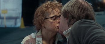Movie still from “Synecdoche, New York” (2008), directed by Charlie Kaufman – An older woman kissing a younger man on the cheek; Close Up shot, Over the shoulder angle