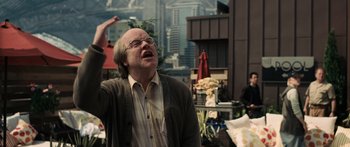 Movie still from “Synecdoche, New York” (2008), directed by Charlie Kaufman – An older man in a brown jacket and glasses; Medium shot, Over the shoulder angle