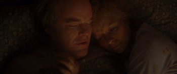 Movie still from “Synecdoche, New York” (2008), directed by Charlie Kaufman – A man and a woman laying in bed together; Close Up shot, Overhead angle