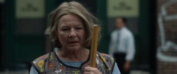 Movie still from “Synecdoche, New York” (2008), directed by Charlie Kaufman – An older woman holding a wooden stick in her hand; Close Up shot, Low angle