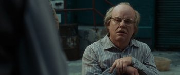 Movie still from “Synecdoche, New York” (2008), directed by Charlie Kaufman – An older man wearing glasses and a striped shirt; Close Up shot, High angle
