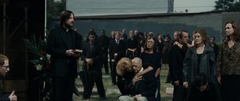 Movie still from “Synecdoche, New York” (2008), directed by Charlie Kaufman – A group of people gathered in a cemetery; Wide shot, Over the shoulder angle
