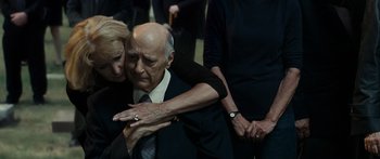 Movie still from “Synecdoche, New York” (2008), directed by Charlie Kaufman – An older man in a suit and tie hugging a younger woman; Close Up shot, High angle