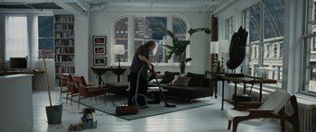 Movie still from “Synecdoche, New York” (2008), directed by Charlie Kaufman – A man is vacuuming in a living room; Wide shot, High angle