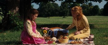 Movie still from “Synecdoche, New York” (2008), directed by Charlie Kaufman – A woman and a girl sitting on a blanket in the grass; Medium shot, High angle