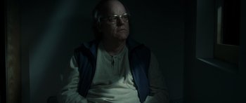 Movie still from “Synecdoche, New York” (2008), directed by Charlie Kaufman – An older man sitting in a dark room; Medium shot, Low angle