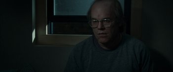 Movie still from “Synecdoche, New York” (2008), directed by Charlie Kaufman – A man with glasses sitting in front of a window; Close Up shot, Over the shoulder angle