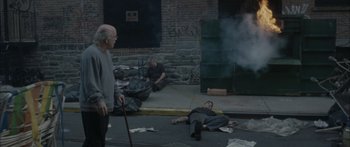 Movie still from “Synecdoche, New York” (2008), directed by Charlie Kaufman – A group of people on the sidewalk near a fire hydrant; Wide shot, High angle
