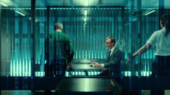 Movie still from “T2 Trainspotting” (2017), directed by Danny Boyle – A man sitting at a table in front of another man; Wide shot, Over the shoulder angle