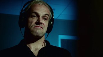 Movie still from “T2 Trainspotting” (2017), directed by Danny Boyle – A man with headphones is listening to music; Close Up shot, Low angle