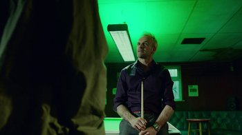 Movie still from “T2 Trainspotting” (2017), directed by Danny Boyle – A man holding a pool cue in his hand; Medium shot, Over the shoulder angle