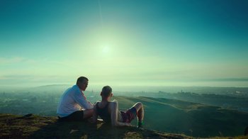 Movie still from “T2 Trainspotting” (2017), directed by Danny Boyle – A man and a woman sitting on top of a hill; Extreme Wide shot, Over the shoulder angle