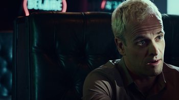 Movie still from “T2 Trainspotting” (2017), directed by Danny Boyle – A person sitting in a chair in a room; Close Up shot, Low angle