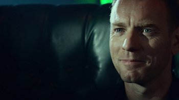 Movie still from “T2 Trainspotting” (2017), directed by Danny Boyle – A person sitting in a chair; Close Up shot, Over the shoulder angle