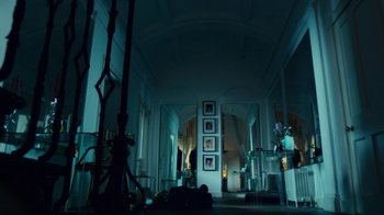 Movie still from “T2 Trainspotting” (2017), directed by Danny Boyle – A room filled with lots of furniture and a large window; Wide shot, Low angle