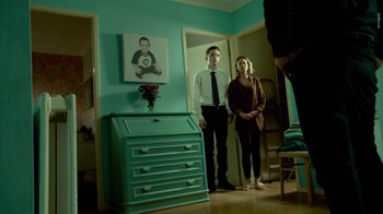 Movie still from “T2 Trainspotting” (2017), directed by Danny Boyle – A man and a woman standing next to a dresser; Wide shot, Low angle