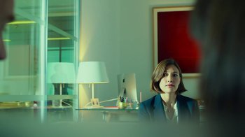 Movie still from “T2 Trainspotting” (2017), directed by Danny Boyle – A woman sitting at a desk in front of a computer; Medium shot, Over the shoulder angle