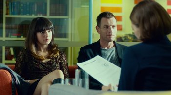 Movie still from “T2 Trainspotting” (2017), directed by Danny Boyle – A man and a woman sitting in front of another man in front of another man; Medium shot, Over the shoulder angle