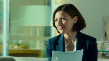 Movie still from “T2 Trainspotting” (2017), directed by Danny Boyle – A woman sitting at a table with papers in front of her face; Close Up shot, Over the shoulder angle