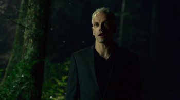 Movie still from “T2 Trainspotting” (2017), directed by Danny Boyle – A man in a black suit standing in the dark; Close Up shot, Low angle