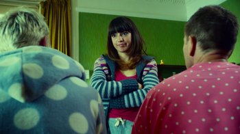 Movie still from “T2 Trainspotting” (2017), directed by Danny Boyle – A woman standing in front of two other people; Medium shot, Over the shoulder angle