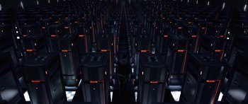 Movie still from “TRON: Legacy” (2010), directed by Joseph Kosinski – A man standing in a room filled with computer equipment; Extreme Wide shot, High angle