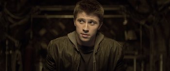 Movie still from “TRON: Legacy” (2010), directed by Joseph Kosinski – A young man in a brown jacket looking into the distance; Close Up shot, High angle