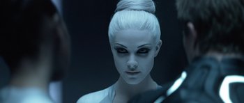Movie still from “TRON: Legacy” (2010), directed by Joseph Kosinski – A woman with white hair and black eye make up; Close Up shot, Over the shoulder angle