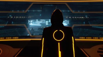Movie still from “TRON: Legacy” (2010), directed by Joseph Kosinski – A person wearing a black jacket and a yellow jacket; Wide shot, Low angle