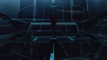 Movie still from “TRON: Legacy” (2010), directed by Joseph Kosinski – A man standing on a platform in the middle of a room; Extreme Wide shot, Low angle